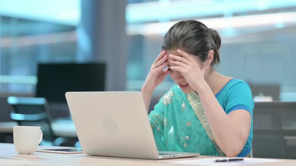 Young Indian Woman having Loss while using Laptop