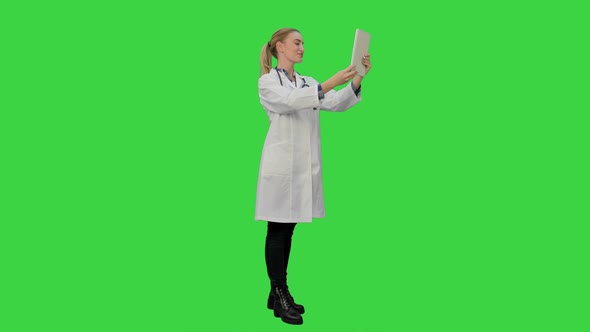 Doctor Greeting Medical Partenrs and Have a Conversation Online Via Tablet on a Green Screen, Chroma