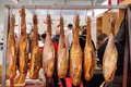 Hamon legs hang from the rack in the market. - PhotoDune Item for Sale