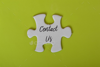 White jigsaw puzzle written with CONTACT US.