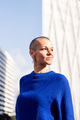 empowered woman with shaved head in cityscape - PhotoDune Item for Sale
