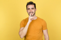 Young man making quiet gesture in studio - PhotoDune Item for Sale