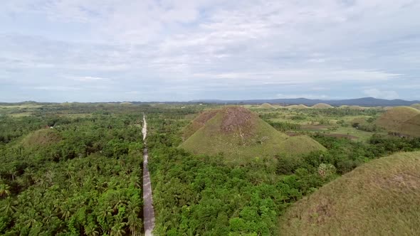 Aerial view road crossing the Chocolate Hills Complex, Batuan, Philippines.