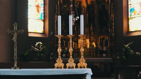 Religious Three Candles Against the Altar Inside the Catholic Chapel