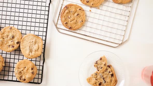 Time lapse. Little girl eating home made chocolate chip cookies wile baking them with her mother.