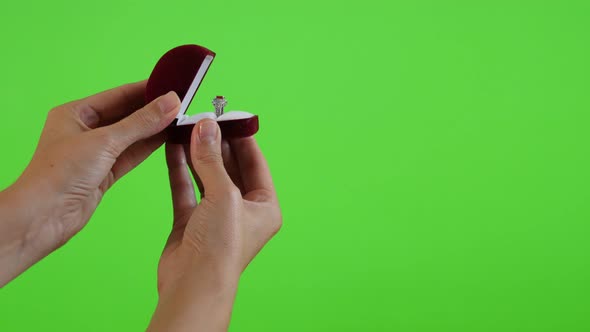 Silver ring in red box presenting in front of green screen 4K 2160p UltraHD footage - Green screen d