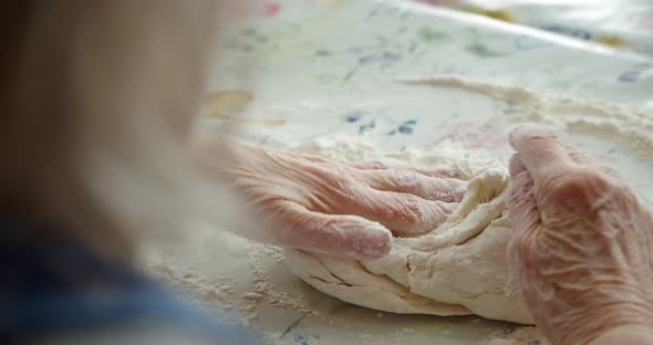 Closeup Old Women's Grandmother's Hands Crumple Dough with Flour Prepare a Pie for Guests