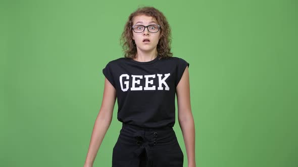 Young Beautiful Nerd Woman Looking Shocked While Covering Mouth