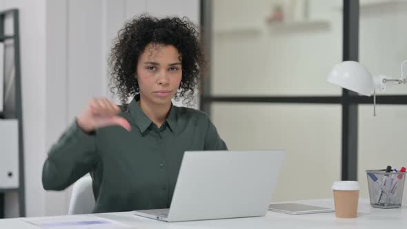 Thumbs Down By African Woman with Laptop