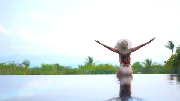 Young asian woman enjoy around outdoor swimming pool for leisure