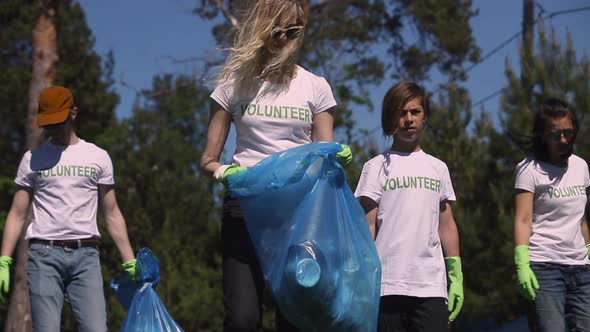 Young People Family Recycle Plastic Bottle Collecting Plastic Waste for Recycling in Green Park on