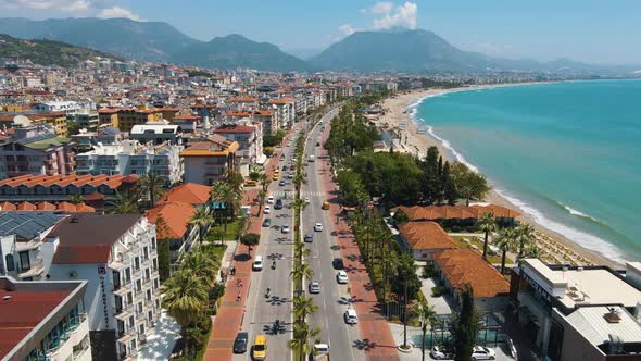 Turkey. Roads, cars, streets of Alanya. Drone video Cityscape with houses in which the red roofs of