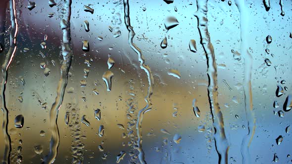 Rain Drops on the Glass in the Spring Afternoon . Blurry Background