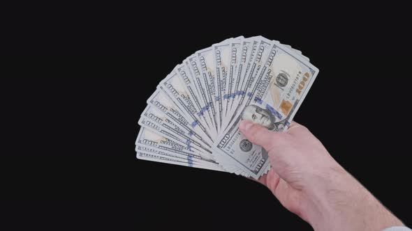 Male Hand Holding a Fan of a Lot of 100 Dollar Bills with Alpha Channel