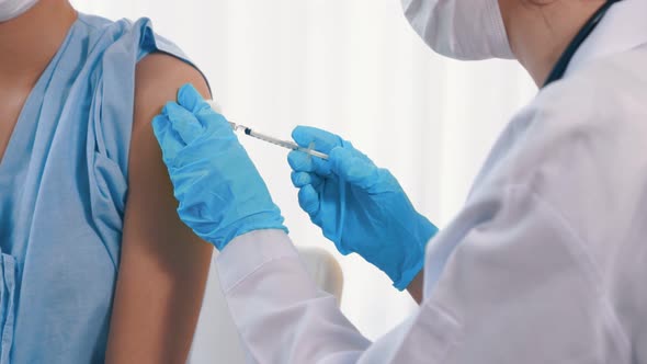 Young Woman Visits Skillful Doctor at Hospital for Vaccination