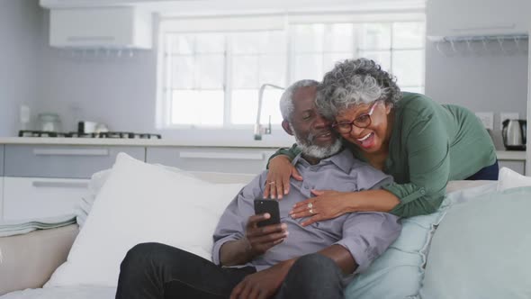 A senior african american couple spending time together at home social distancing in quarantine.