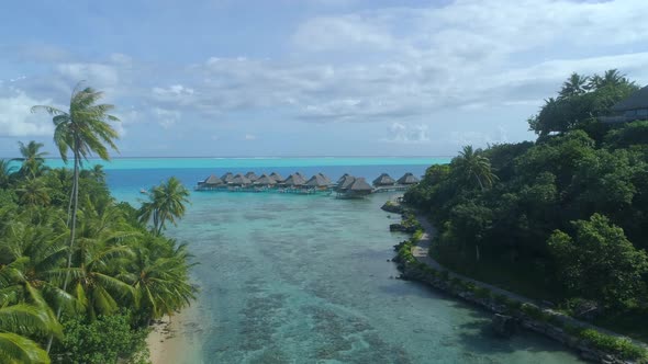 Aerial drone view of a luxury resort and overwater bungalows in Bora Bora tropical island