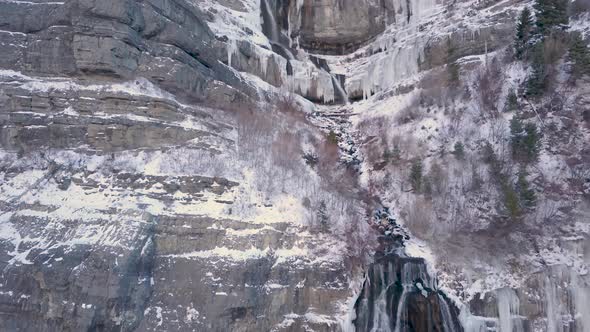 Winter wonderland in the scene of a half frozen waterfall - close up dolly in