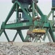 A Cargo Magnetic Crane Unloads the Cast Iron Onto the Pier - VideoHive Item for Sale