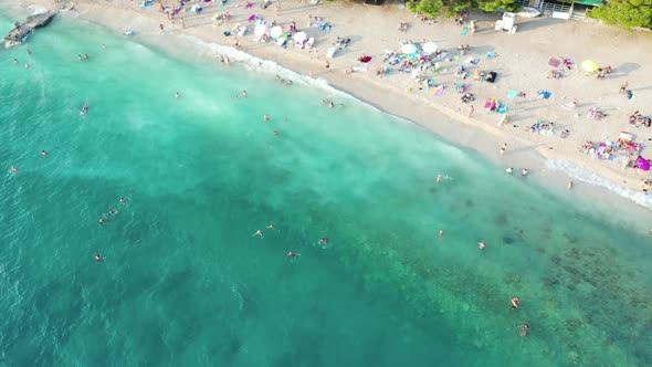 Aerial top down view of people swimming in sea