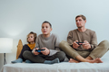 Father and children boys with joysticks playing video games at home - PhotoDune Item for Sale