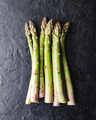 Top view of green asparagus sprouts on black background - PhotoDune Item for Sale