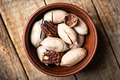 Dried organic Pecan nuts in orange ceramic bowl - PhotoDune Item for Sale