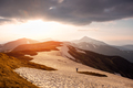 Lonely tourist on snowy mountains during incredible sunset - PhotoDune Item for Sale