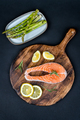 Fresh raw salmon slice with lemon and rosemary on a wooden board - PhotoDune Item for Sale