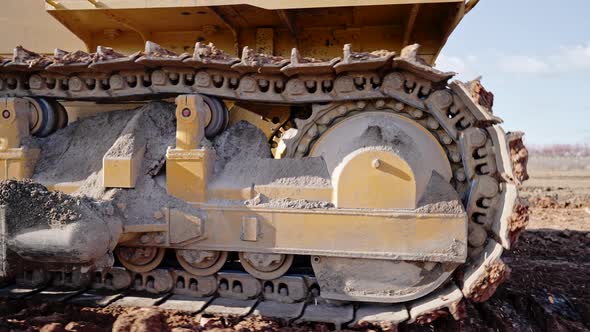 Tracking Shot of Crawler Bulldozer Working on Construction Site or Quarry