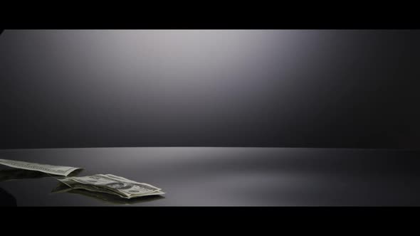 American $100 Bills Falling onto a Reflective Surface - MONEY 0004