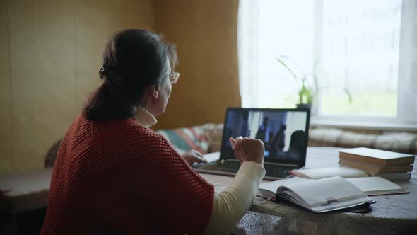 Training Online, Old Woman Is Studying Online with Help of Modern Technologies Sitting at Home By a