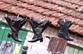 Wet shoes hanging on the clothesline along with other laundry - PhotoDune Item for Sale