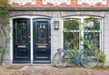 House entrance with two doors and bicycle in Amsterdam - PhotoDune Item for Sale