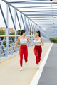 Two female athletes running smiling - PhotoDune Item for Sale