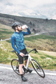 A cyclist stops and drinks from his canteen - PhotoDune Item for Sale