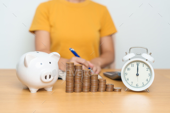 sion, Investment, Wealth Business and Financial concepts. woman with coins stack, piggy bank and clock for money Counting and deposit