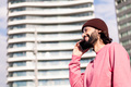 joyful young guy on phone in bright city morning - PhotoDune Item for Sale