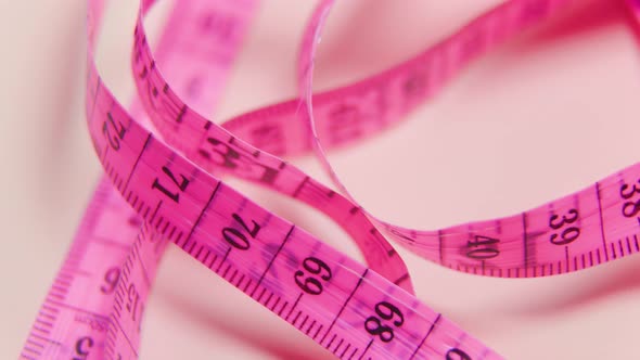 Close Up of a Violet Measure Tape on White Rotating