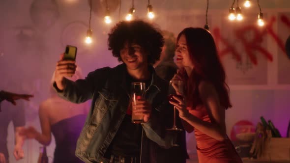 Young Couple Taking Selfie During Party