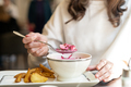 Woman eating cold soup holodnik in a cafe. Female eating beetroot soup with fried potatoes in a rest - PhotoDune Item for Sale