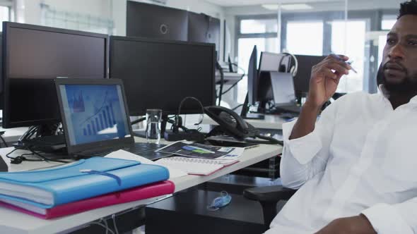 Thoughtful man sitting on his desk in office