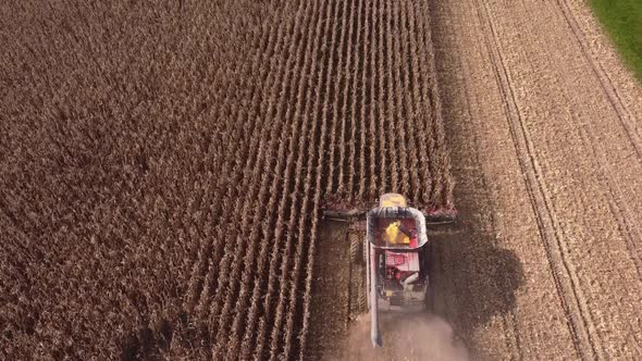 Combine Harvesting Corn In Southeast Michigan Near Carlton Michigan On A Sunny Day Of Summer - aeria