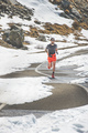 A man athlete runs on a road through an alpine pass - PhotoDune Item for Sale