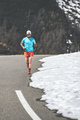 Male runner uphill on alpine pass road - PhotoDune Item for Sale