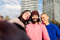 selfie of three happy friends smiling in the city - PhotoDune Item for Sale