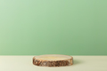 Wood slice podium on green background for cosmetic product mockup - PhotoDune Item for Sale