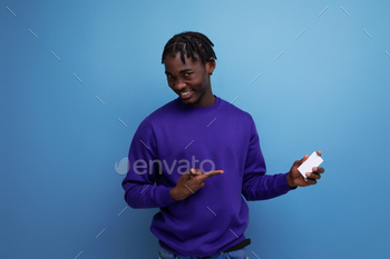 handsome african young man with money card in his hand