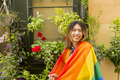 LGBTQ+ youth with pride flag in street - PhotoDune Item for Sale