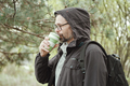 Bearded man drinks from reusable silicone mug. Camping, hiking, sustainable consumption. - PhotoDune Item for Sale